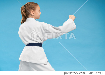 View from back of girl doing karate on isolated background View from back of girl doing karate on isolated background 50503790