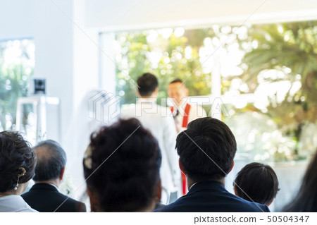 Bride and groom swearing to the wedding priest Bride and groom swearing to the wedding priest 50504347