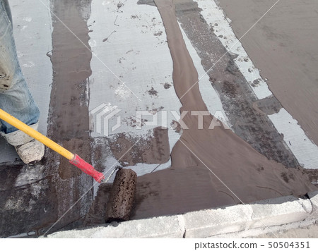 Waterproofing membrane applied by workers. Waterproofing membrane applied by workers. 50504351