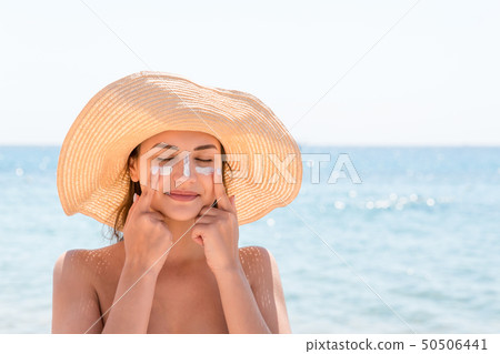 Sun shaped sunscreen on woman Sun shaped sunscreen on woman 50506441