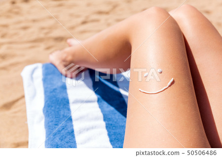 Sun shaped sunscreen on woman Sun shaped sunscreen on woman 50506486