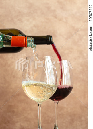 White and red wine pouring into glasses 50507512