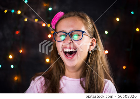 Portrait of cheerful teenage girl on festive Portrait of cheerful teenage girl on festive 50508320