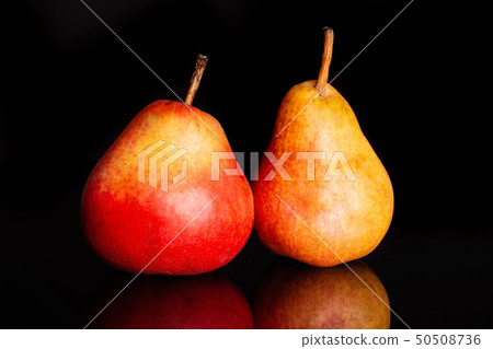 Fresh red pear isolated on black glass Fresh red pear isolated on black glass 50508736