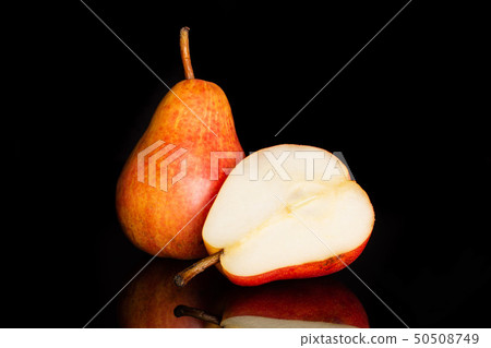 Fresh red pear isolated on black glass Fresh red pear isolated on black glass 50508749