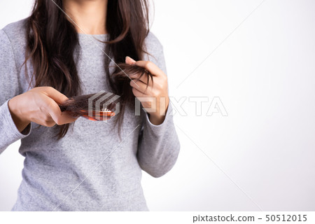 Woman show her brush with damaged hair Woman show her brush with damaged hair 50512015