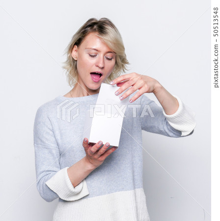 Small gift in the hands of a woman. 50513548