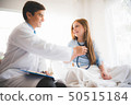 Doctor pediatrician with patient little girl. 50515184