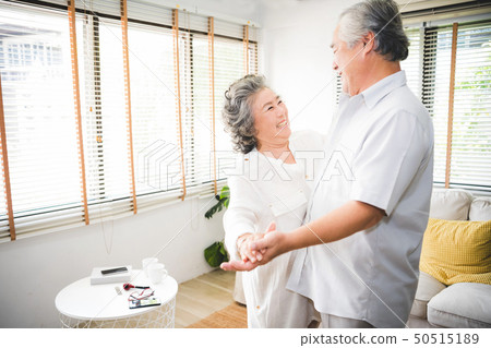 Lover senior couple dance together at home. Lover senior couple dance together at home. 50515189