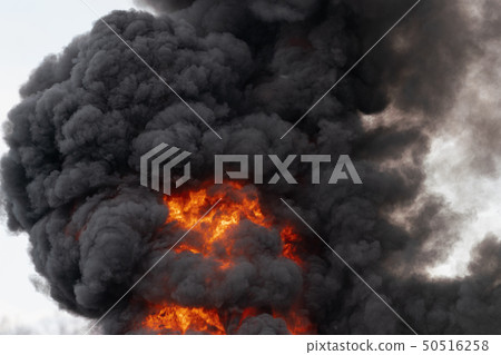 Huge flames of strong red fire, motion clouds sky 50516258