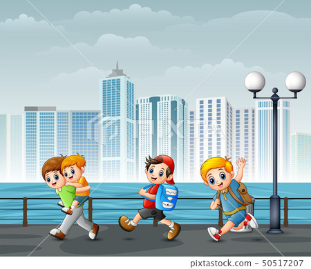 Happy children playing at the riverbank across Happy children playing at the riverbank across 50517207