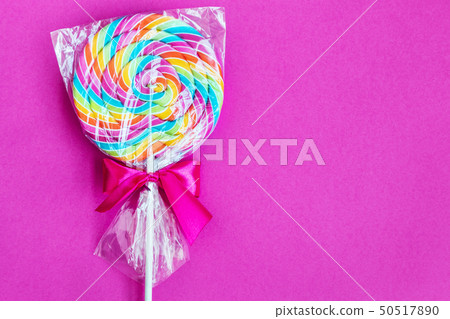 striped spiral multicolor Lollipop on pink background  50517890