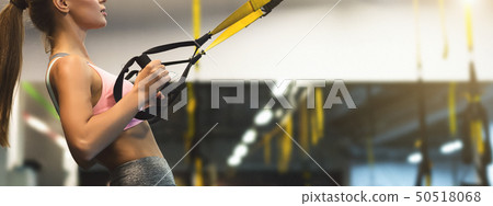 Trx training. Woman working out with fitness straps 50518068