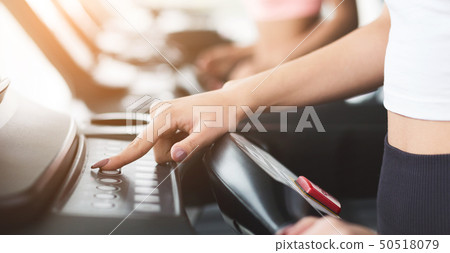 Customize exercises. Woman training on treadmill in gym 50518079