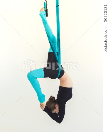 Woman practicing fly yoga over white background Woman practicing fly yoga over white background 50520121