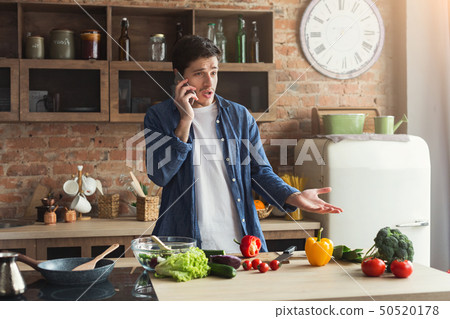 Disappointed man preparing healthy food in the home kitchen Disappointed man preparing healthy food in the home kitchen 50520178