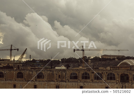 View to old docks and port cranes in evening View to old docks and port cranes in evening 50521602