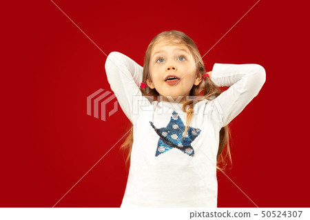 Beautiful emotional little girl isolated on red background Beautiful emotional little girl isolated on red background 50524307