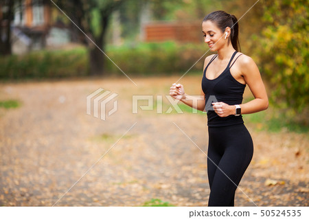 Fitness. Beautiful young woman doing exercises in the park 50524535
