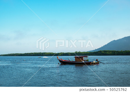 Fisherman Boat in the Morning Light in the Sea 50525762