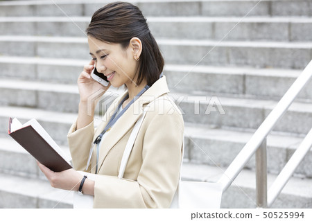 Business woman making a phone call Business woman making a phone call 50525994