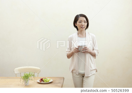 A woman holding a cup A woman holding a cup 50526399