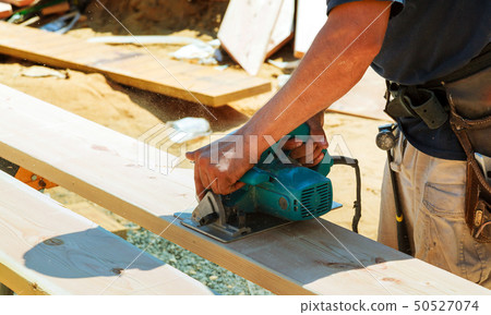 Close-up of a carpenter using a circular saw Close-up of a carpenter using a circular saw 50527074
