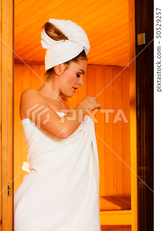 woman relaxing in wooden sauna room 50529257