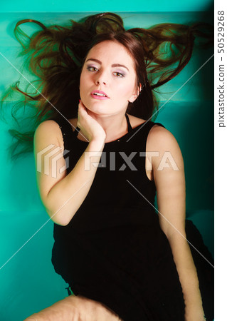 Sexy seductive woman in black dress in water. Sexy seductive woman in black dress in water. 50529268