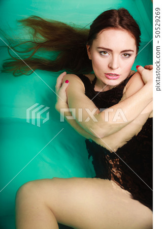 Sexy seductive woman in black dress in water. Sexy seductive woman in black dress in water. 50529269