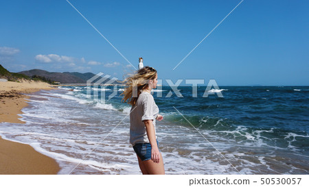 Beautiful bohemian styled and tanned girl at the beach in sunlight 50530057
