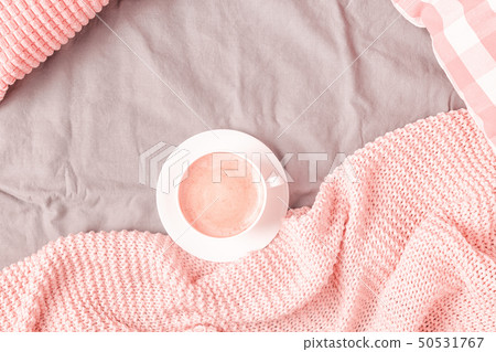 Bed with pink knitted plaid and coffee 50531767