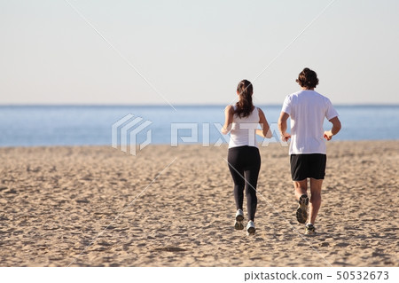 Man and woman running in the beach 50532673