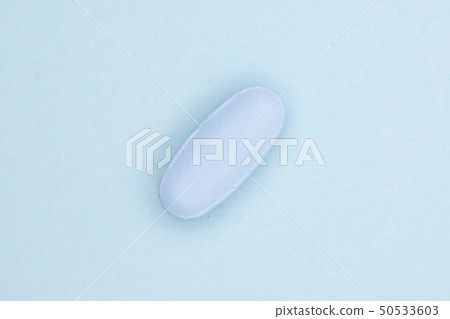 Blue medical pills on light blue Blue medical pills on light blue 50533603