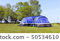 Camping blue family tent pitched in wild campsite 50534610