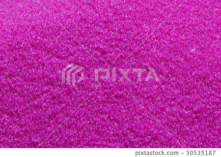 The pink pellet of raw plastic material . The pink pellet of raw plastic material . 50535187