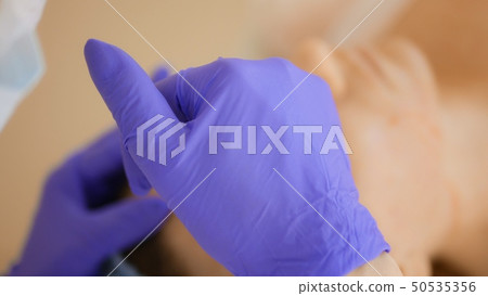 The cosmetologist makes injections, anti-aging procedures for tightening and smoothing wrinkles on 50535356