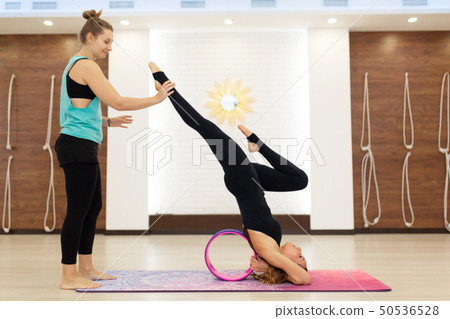couple of young womans in a sportswear yoga couple of young womans in a sportswear yoga 50536528