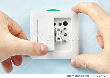 Worker installs new push button. Worker installs new push button. 50537378