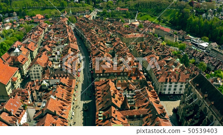Flight over tiled roofs of the Old City of Bern, Switzerland Flight over tiled roofs of the Old City of Bern, Switzerland 50539403