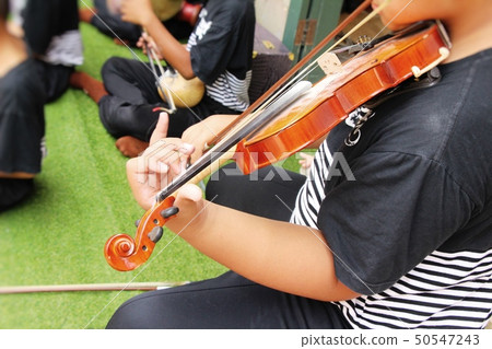 Young musician playing the violin Young musician playing the violin 50547243