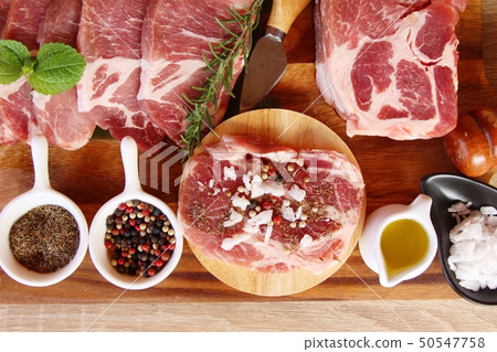 Raw pork steaks with salt and pepper 50547758