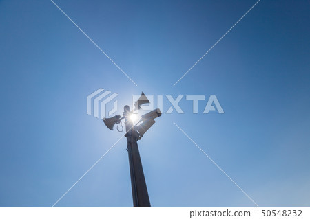 Surveillance camera and speaker attached to telephone pole Surveillance camera and speaker attached to telephone pole 50548232