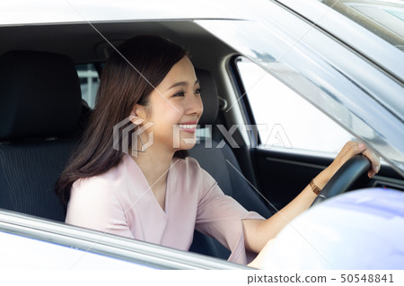 Asian women driving a car and smile happily Asian women driving a car and smile happily 50548841
