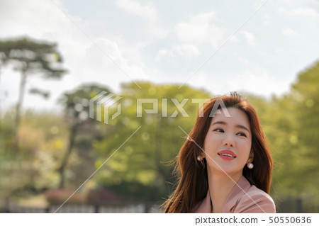 A woman enjoying a happy everyday scene A woman enjoying a happy everyday scene 50550636