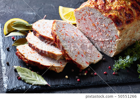sliced chicken meatloaf on a slate tray sliced chicken meatloaf on a slate tray 50551266