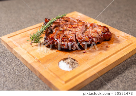 food, delicious and craft concept - cutting horse meat steak on wooden desk 50551478