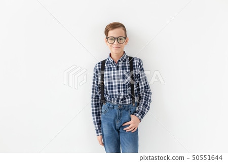 teenager, children and fashion concept - kid dressed in plaid shirt posing over white background 50551644