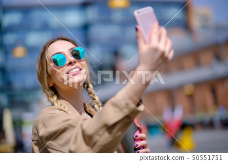 Young woman selfie in the street with a 50551751
