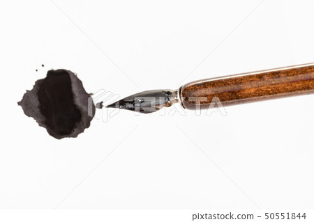 nib of penholder and black ink blot on white paper nib of penholder and black ink blot on white paper 50551844